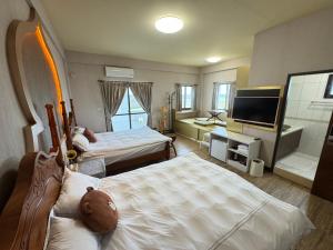 Postel nebo postele na pokoji v ubytování 澎湖藍海會館Blue Ocean Inn Penghu + 37 fotografií