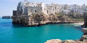 a castle on a cliff next to the water at G.H. Polignano a Mare in Polignano a Mare