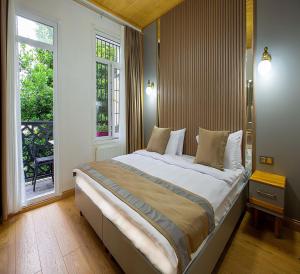 Una cama o camas en una habitación de Guldehan Hotel