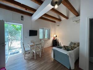a living room with a couch and a table at Sweet holiday house in Veli Iž