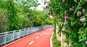 a red road with flowers on the side of a bridge at Grand Bravo Guilin in Guilin