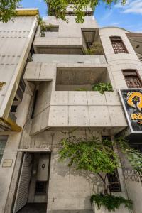 a tall white building with a tree in front of it at Oday Stay Boutique Hotel Da Nang - 2 Minutes to Dragon Bridge in Danang +65 photos