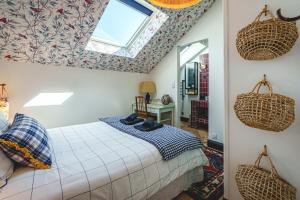 a bedroom with a bed and a skylight at La Maison D'Ambre - Jacuzzi - Sauna- Clim in Saumur +60 photos