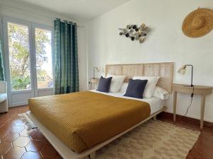 a bedroom with a large bed and a window at Kallinera in Porto-Vecchio +54 photos