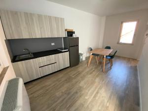 a room with a table and a kitchen with a table and chairs at Jesi Home in Iesi