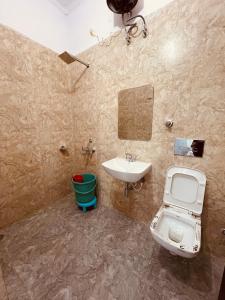a bathroom with a toilet and a sink at Vishram Guest House in Jhājra +43 photos