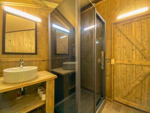 a bathroom with a sink and a shower and a mirror at Càmping Parc Gualba in gualba de Dalt +35 photos