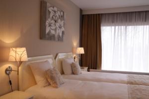 Postel nebo postele na pokoji v ubytování First Euroflat Hotel