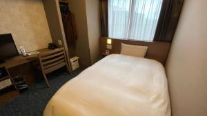 Postel nebo postele na pokoji v ubytování Dormy Inn Kobe Motomachi Natural Hot Springs