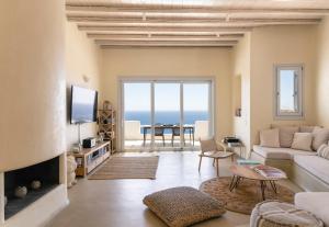 a living room with a view of the ocean at Luxury villa with stunning views above Kalo Livadi in Mýkonos City