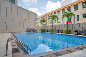 a large swimming pool in front of a building at Nagoya Hill Hotel Batam in Nagoya