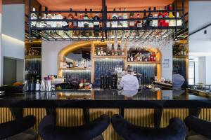 a bar at a restaurant with people sitting at it at LIMNI Boutique Experience Evia in Limne
