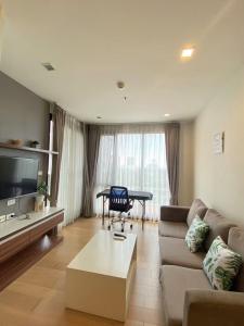 a living room with a couch and a table at 清迈市区Astra condo 屋顶无边泳池可步行至夜市 in Chiang Mai