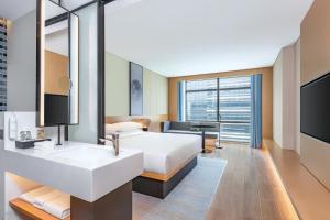 a hotel room with a bed and a sink at Fairfield by Marriott Beijing Daxing Airport in Beijing