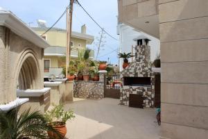 a patio with a stone oven in a house at Villa Moné in Koskinou