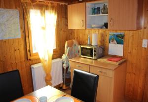 a kitchen with a table and a microwave on a counter at Chalet Chinegga in Stalden