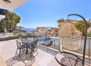 a patio with a table and chairs and a swing at Happy Kaş Apart in Kaş