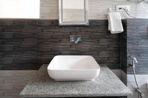 a bathroom with a white toilet on a counter at SHUKPA RESIDENCY LoWER TUKCHA in Leh +23 photos