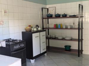 a kitchen with a stove and shelves with dishes at Trio Trails Apartments in Livingstone