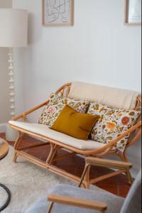 a bench with pillows on it in a living room at Deux chambres avec terrasse dans le centre ville d'Aix en Provence in Aix-en-Provence