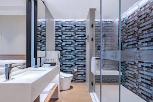 a bathroom with a sink and a glass shower at Fairfield by Marriott Beijing Daxing Airport in Beijing