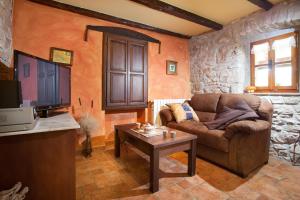 a living room with a couch and a table at Villa Favola, a rustic retreat surrounded by beautiful nature in Vinež