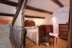 a bedroom with a large bed and a dresser at Villa Favola, a rustic retreat surrounded by beautiful nature in Vinež +23 photos