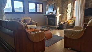 a living room with chairs and a fireplace at Casa da Lage - Vistas rio - Gerês - Lareiras in Geres +107 photos