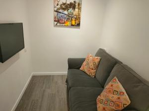a living room with a couch and a tv at Sea loft with a huge bed in Icod de los Vinos