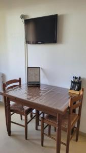 a table with a laptop sitting on top of it at Appartement BARBOTAN LES THERMES in Cazaubon +1 photo