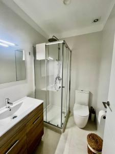 a bathroom with a shower and a toilet and a sink at VILLA MAR in Cala'n Bosch