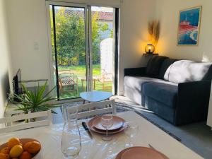 a living room with a couch and a table at Studio in Boucau