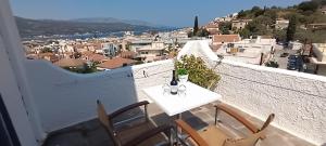 a table and chairs on a balcony with a view at ODYSSEAS HOTEL SAMOS in Samos