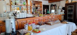 a kitchen with a table with food and drinks at ODYSSEAS HOTEL SAMOS in Samos +45 photos