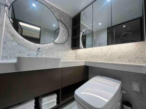 a bathroom with a toilet and a sink and a mirror at Seoul Modern Cozy Stay in Seoul +40 photos