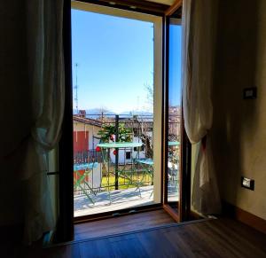 a large window with a view of a yard at Pasubio 13 in Selvino