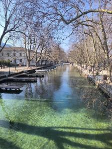 a river with benches and trees in a park at La petite Venise des Alpes, Ultra centre 1 à 5 Pers in Annecy