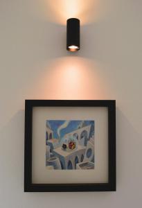 a picture of a table and a light on a wall at La Casetta di via Tasso in Piombino