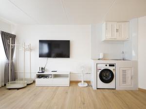a living room with a washing machine and a tv at 3 Beds,WiFi,Washing Machine,IMPACT Arena at T9 in Ban Bang Phang