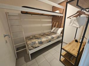 a bedroom with a bunk bed and a ladder at SolMarina Holiday House in Marina di Ragusa