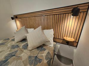 a bedroom with a bed with pillows on it at SolMarina Holiday House in Marina di Ragusa +13 photos