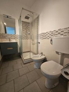 a bathroom with a toilet and a sink and a shower at SolMarina Holiday House in Marina di Ragusa