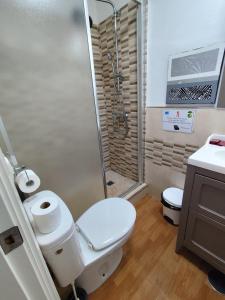 a bathroom with a toilet and a shower at El Refugio 2 Pax - WIFI in Tarifa