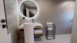 a bathroom with a sink and a mirror at Stay Here Living Apartments in Thiersee +47 photos