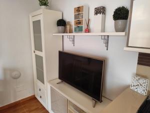 a living room with a flat screen tv on a wall at El Refugio 2 Pax - WIFI in Tarifa