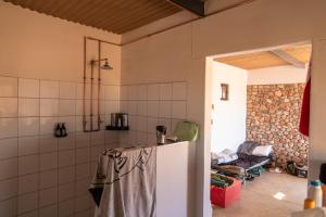 a kitchen with a refrigerator and a living room at Spreetshoogte Campsite in Namibgrens