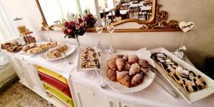 a white table with pastries and desserts on it at Hotel Anny in Cervia