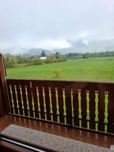 a view of a field from a balcony at House Mara in Korenica