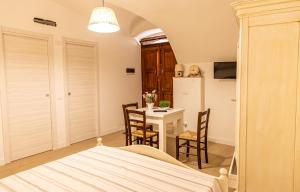 a bedroom with a bed and a table and chairs at Il Borghetto in Gerace