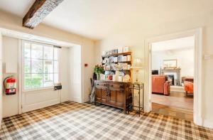 a living room with a door open to a living room at Old School House - with private onsite parking in Hawkshead